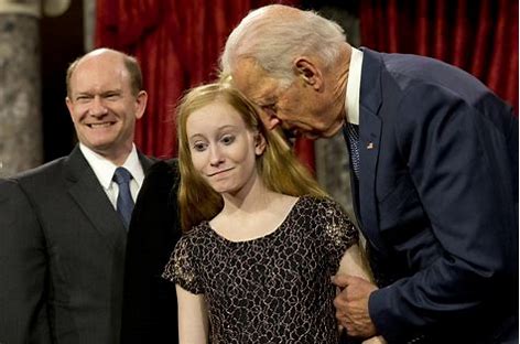 Joe Biden standing close to young girl